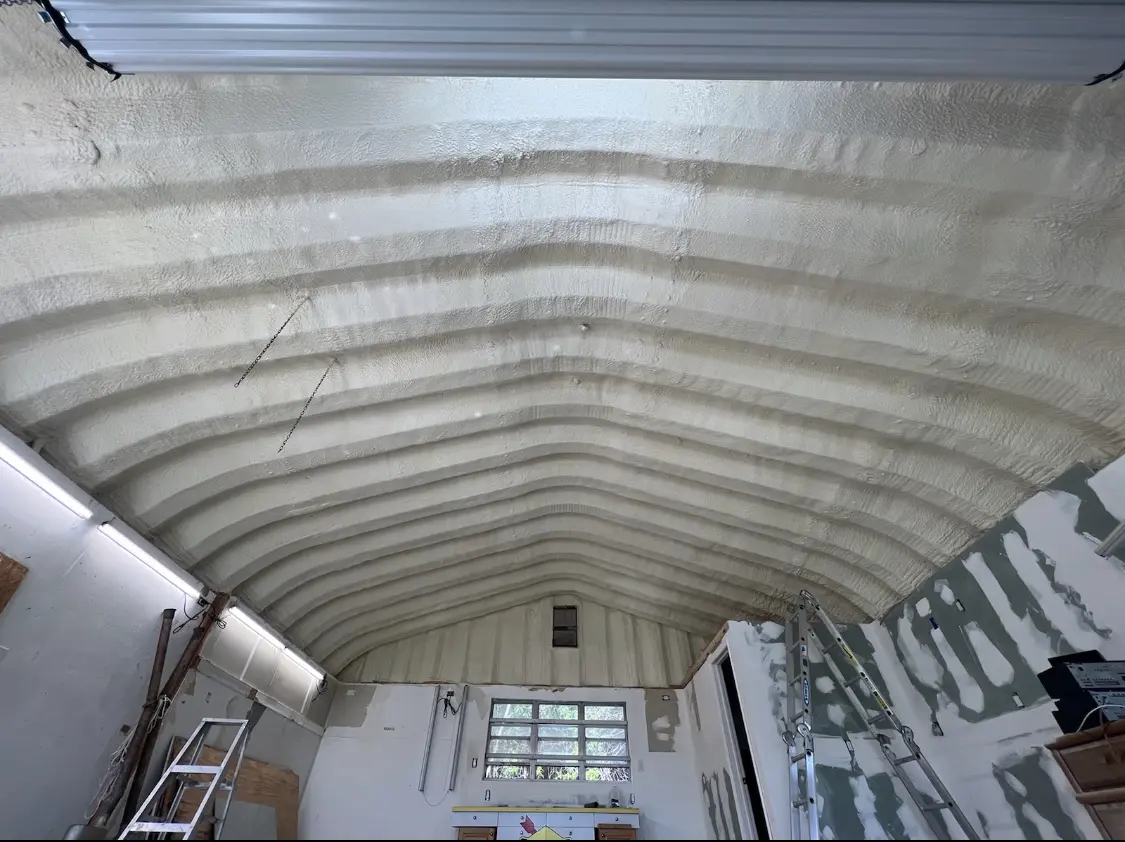 Spray polyurethane foam applied to the underside of a metal roof deck in Burlington
